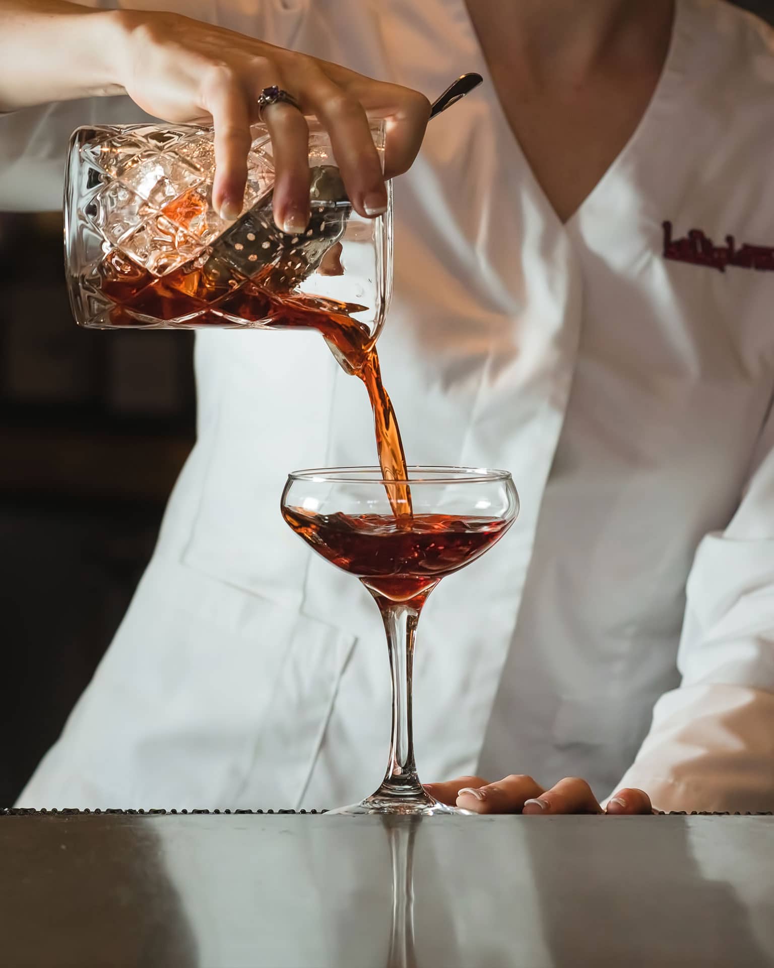 Bartender pouring a cocktail